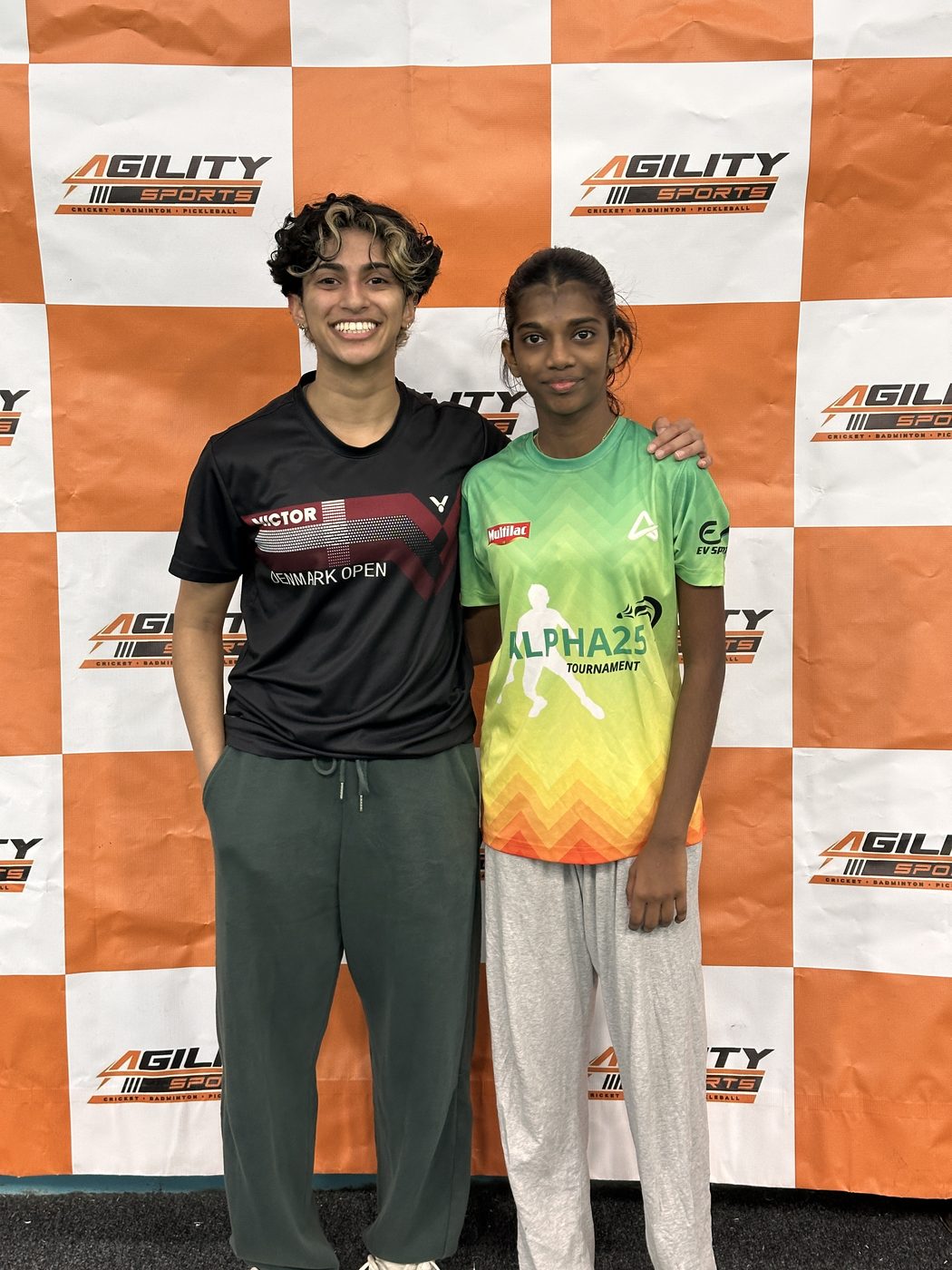 Two young players together at a badminton tournament